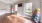 a room with a wood floor and a window with balloons