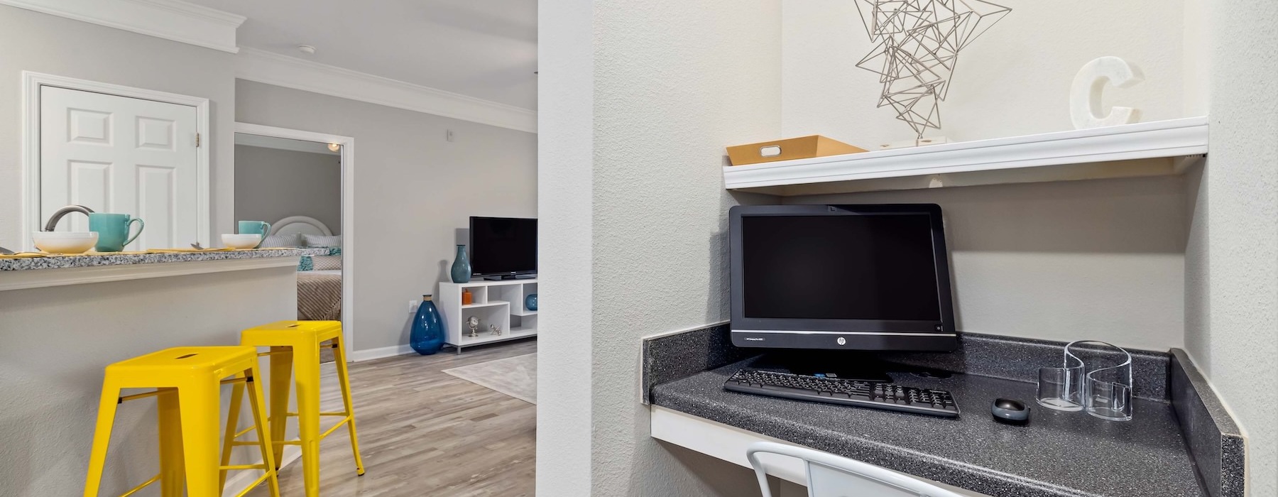 a room with a desk and computer