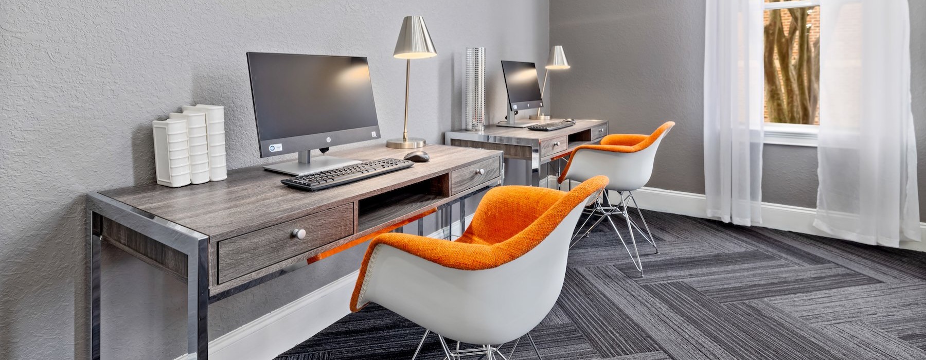 a room with a desk and computer