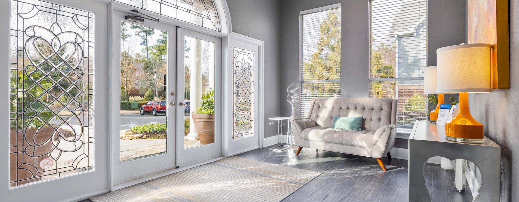 a room with a couch and large glass door