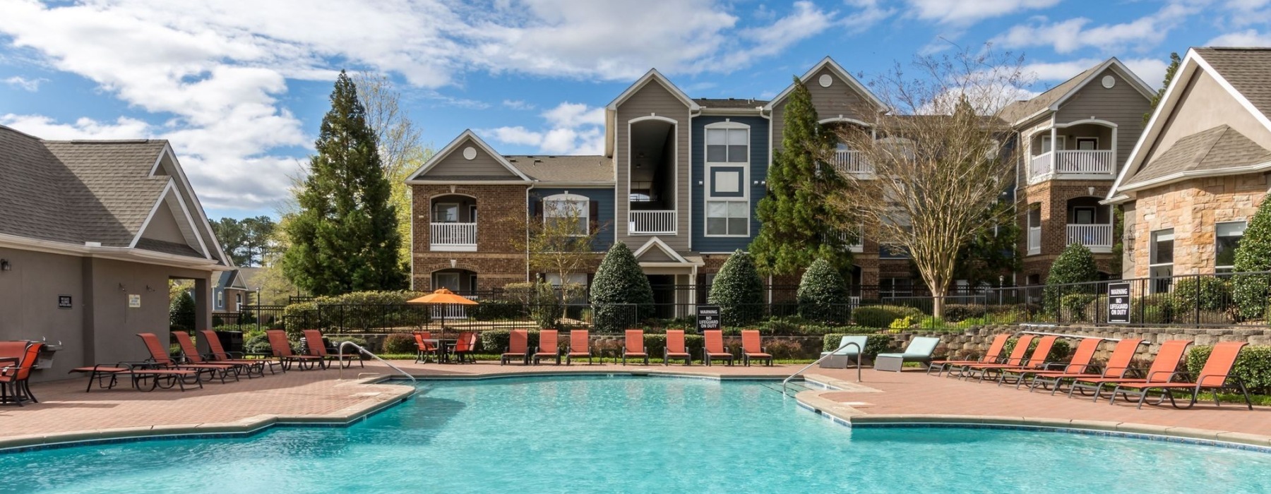 Resort-style swimming pool with lounge seating