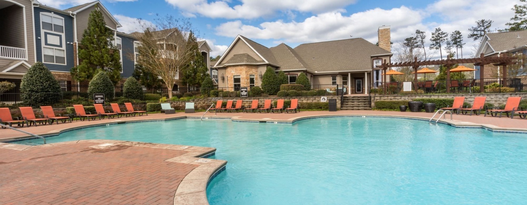a swimming pool with chairs around it