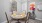a dining table with a painting on the wall