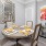 a dining table with a painting on the wall