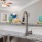 a kitchen with a sink and a fan