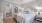 a bedroom with a fan and a bed