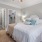 a bedroom with a fan and a bed