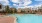 a swimming pool with chairs around it
