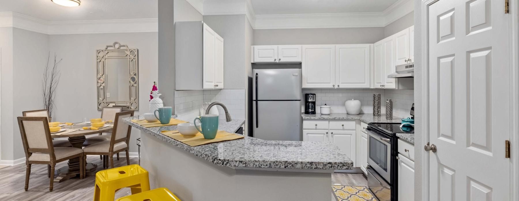a kitchen with white cabinets